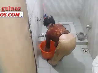 Indian sweeping taking a bath in the bathroom